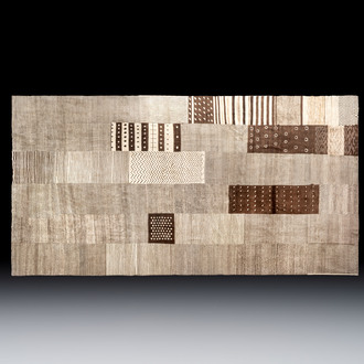 A very large Persian hand-knotted woollen carpet with a geometric patchwork design, 20th C.