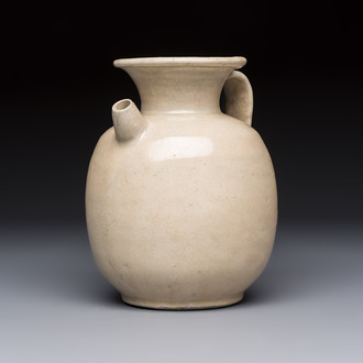 A Chinese cream-glazed ewer with a barrel-shaped body, Hebei/Henan provinces, Tang/Five Dynasties