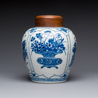 A Chinese blue and white 'Antiquities and Flower Baskets' vase with a wooden cover, Kangxi