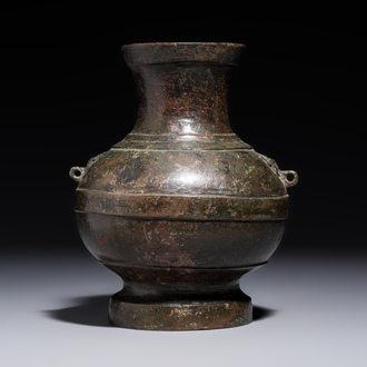 A miniature Chinese archaic bronze wine vessel with Taotie handles, 'Hu 壺', Han