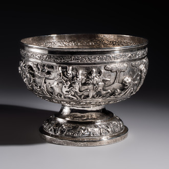 A large repoussé silver footed bowl depicting a hunting scene, India, late 19/early 20th C.