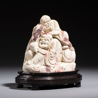 A Chinese carved soapstone 'Luohan' group on a wooden stand, Republic