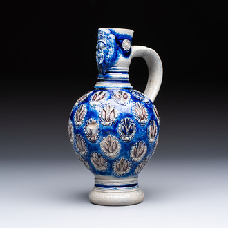 A Westerwald stoneware jug with a lion's head and moulded floral design, Germany, 17th C.