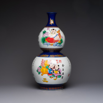 A large Chinese polychrome-decorated blue-ground double-gourd vase, 20th C.