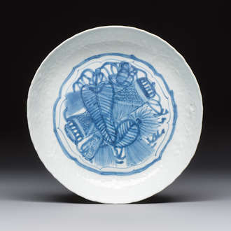 A Chinese blue and white plate with a relief-moulded rim, Wanli