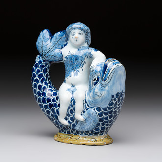 A blue and white Dutch Delft ewer in the shape of a putto on a dolphin on a wavy green ground, 18th C.