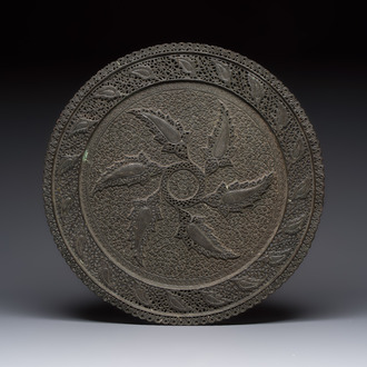 A large Persian reticulated copper-alloy dish with paisley design, Qajar, 19th C.