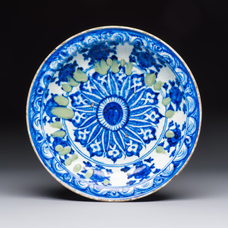 A Persian blue, white, and green glazed dish with stylised floral design, Safavid, 17/18th C.