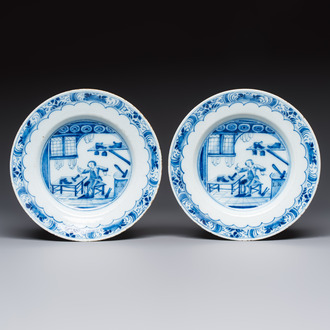 A pair of rare blue and white Dutch Delft 'Shoemaker' plates, 18th C.