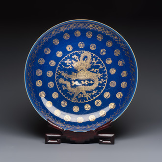 A large Chinese gilt-decorated powder-blue-ground 'Dragon' dish on a later wooden stand, Guangxu mark and of the period