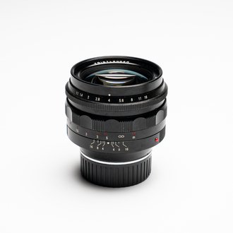 A Voigtländer Nokton 50 mm F1.1 lens and hood