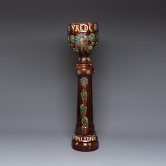 A very large Art Nouveau Flemish pottery four-piece jardinière and stand, inscribed 'VREDE' and 'WELKOM', early 20th C.