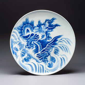 A massive Japanese blue and white 'Dragon among Sea Waves' dish, probably Arita, Meiji, 19th C.
