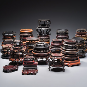 A collection of 70 Chinese wooden stands, 19/20th C.