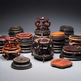A collection of 40 mainly Chinese wooden stands, 19/20th C.