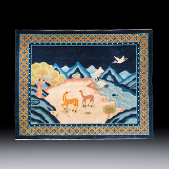 A Chinese woollen 'Cranes and Deer' carpet, 20th C.