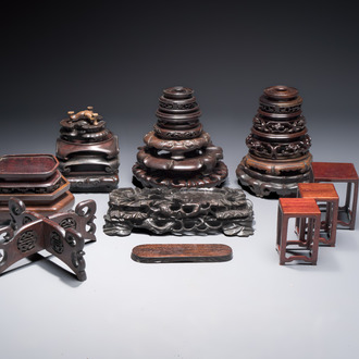 A collection of 25 Chinese wooden stands, 19/20th C.