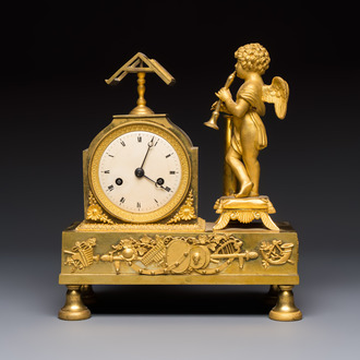 A French fire-gilt mantel clock with a music making cherub, early 19th C.