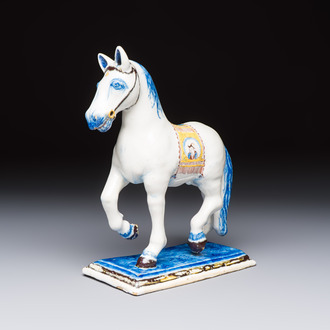 A polychrome Dutch Delft model of a standing horse with a figurative saddle cloth, 18th C.