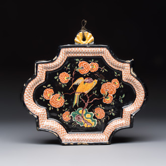 An exceedingly rare polychrome black-ground Dutch Delft plaque with a parrot, 18th C.