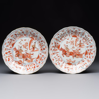 A pair of Chinese gilt iron-red-decorated 'Falconry' plates, Kangxi