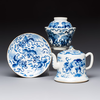 A Chinese blue and white 'Buddhist Lion' teapot, covered bowl and a saucer, various marks, 19th C.
