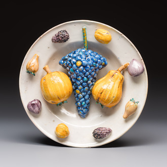 An unusual polychrome Swiss faience trompe l'oeil dish with various fruits, Winterthur, workshop of David Pfau II, 17th C.
