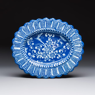 An oval French Persian-blue-ground white-decorated faience dish with butterflies and foliage, Nevers, 17th C.