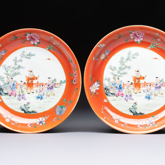 A pair of Chinese famille rose coral-ground 'Playing Boys' plates, Jiaqing marks, Republic