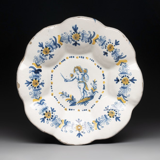 A blue, white and yellow Dutch Delftware dish with a putto, Delft or Haarlem, 17th C.