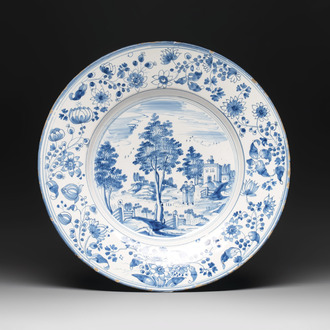 A large blue and white 'landscape and figures' dish, Frankfurt, 17th C.