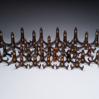 A collection of 35 Chinese folding wooden plate stands, 20th C.