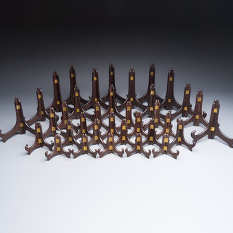 A collection of 35 Chinese wooden folding plate stands, 20th C.