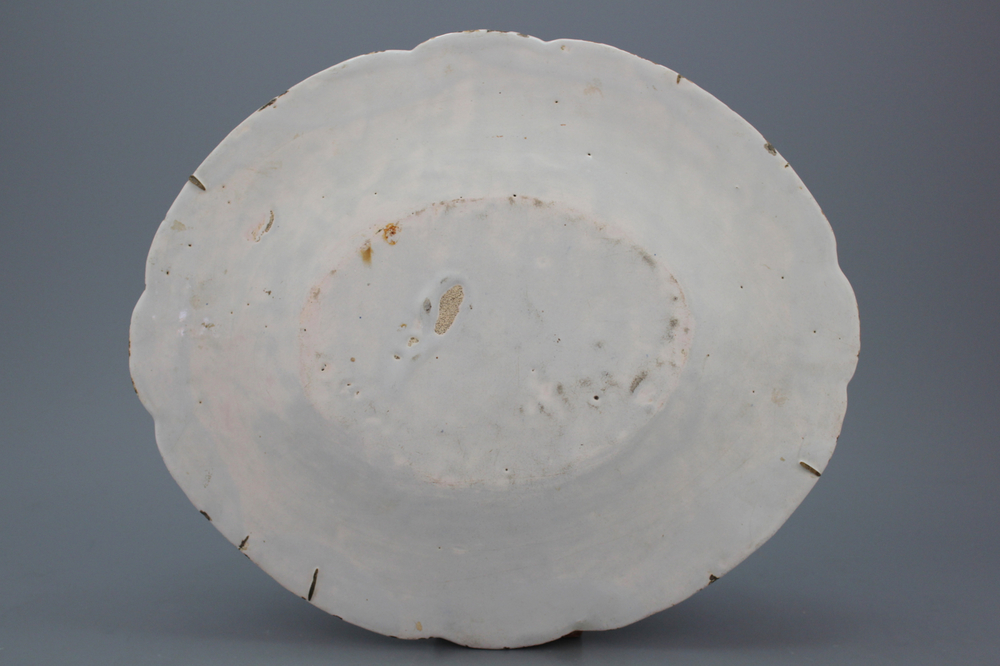 A large French faience relief molded oval blue and white dish with a very fine floral decoration, 18th C.