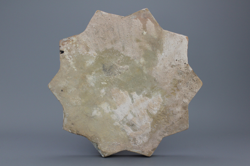 A Timurid cuerda seca star-shaped tile, 15th C.