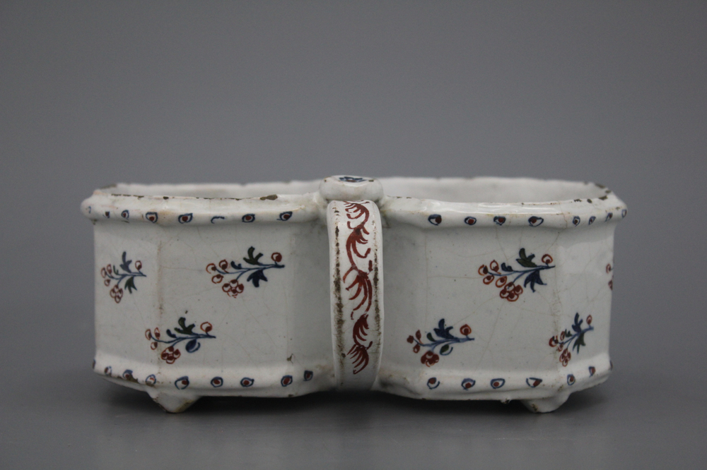 A Brussels faience "floral hedge" cruet stand, 18th C.