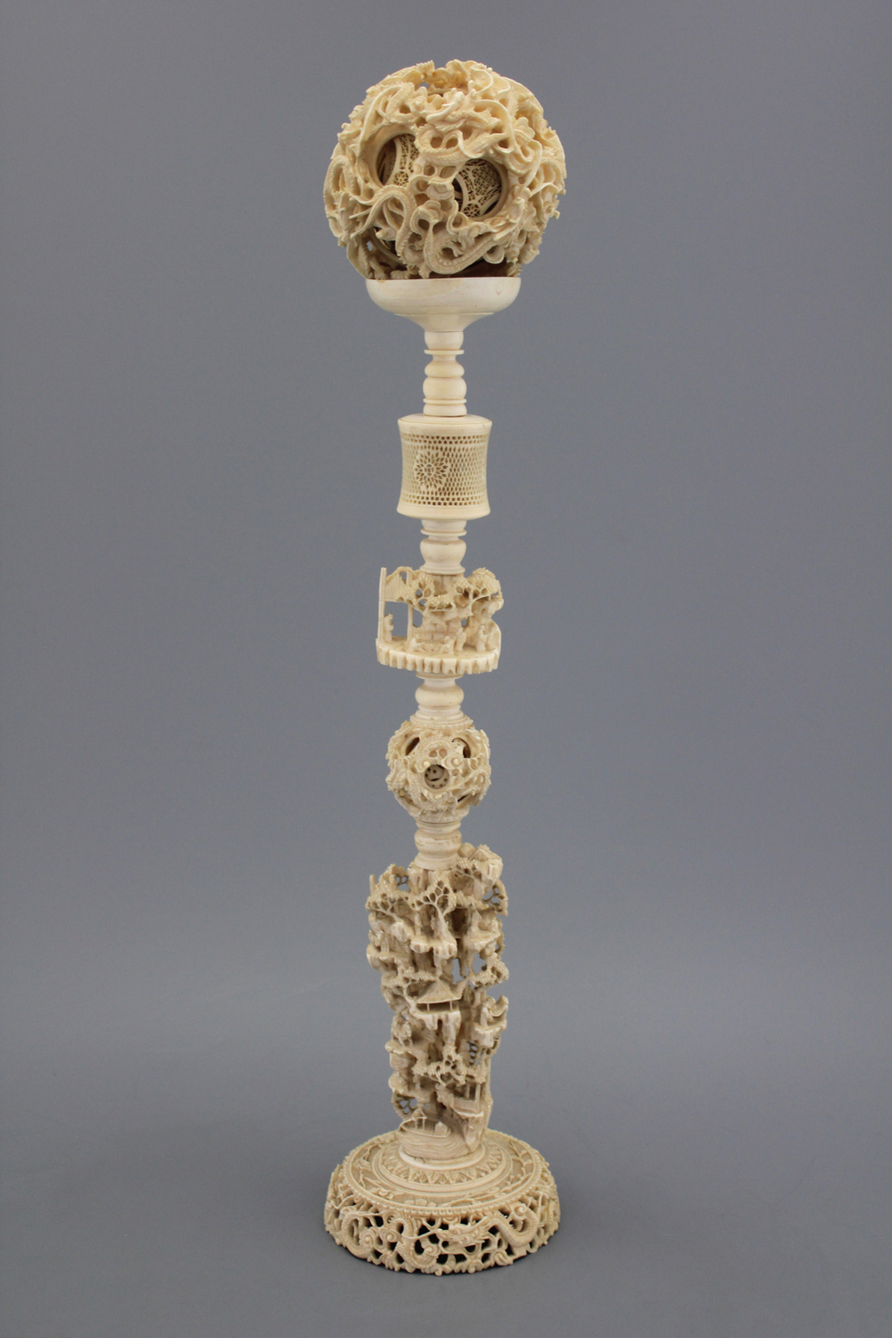 A large Chinese carved ivory puzzle ball on stand, 1st half 20th C.