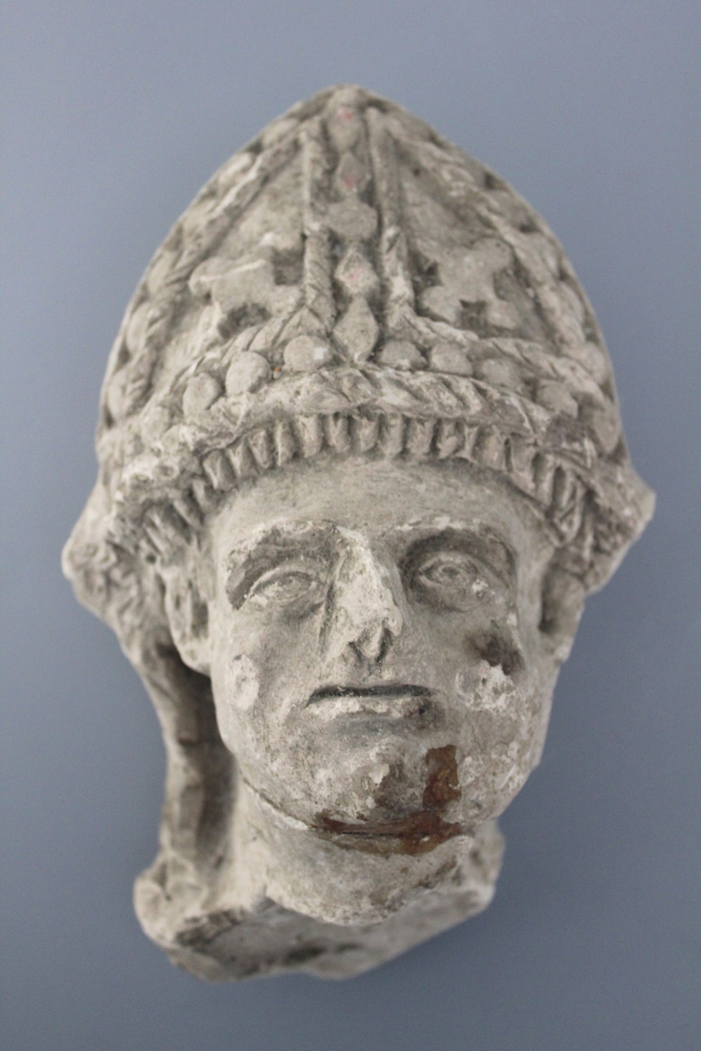 A carved stone head of a saint, 16th C.