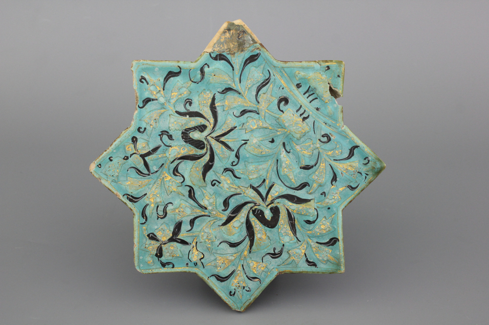 A turquoise ground Lajvardina cold painted star-shaped tile, 14th C.