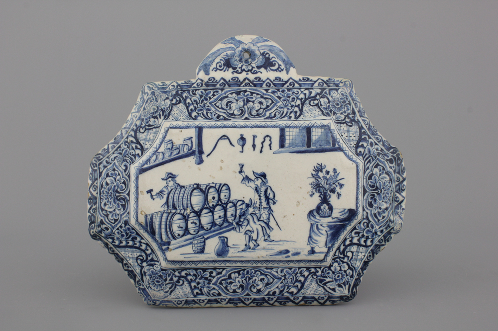 A rare Dutch Delft blue and white plaque of a wine tasting, 18th C.