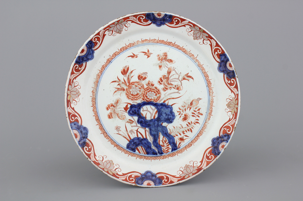 A Dutch Delft dor&eacute; plate with flowers and birds, ca. 1720