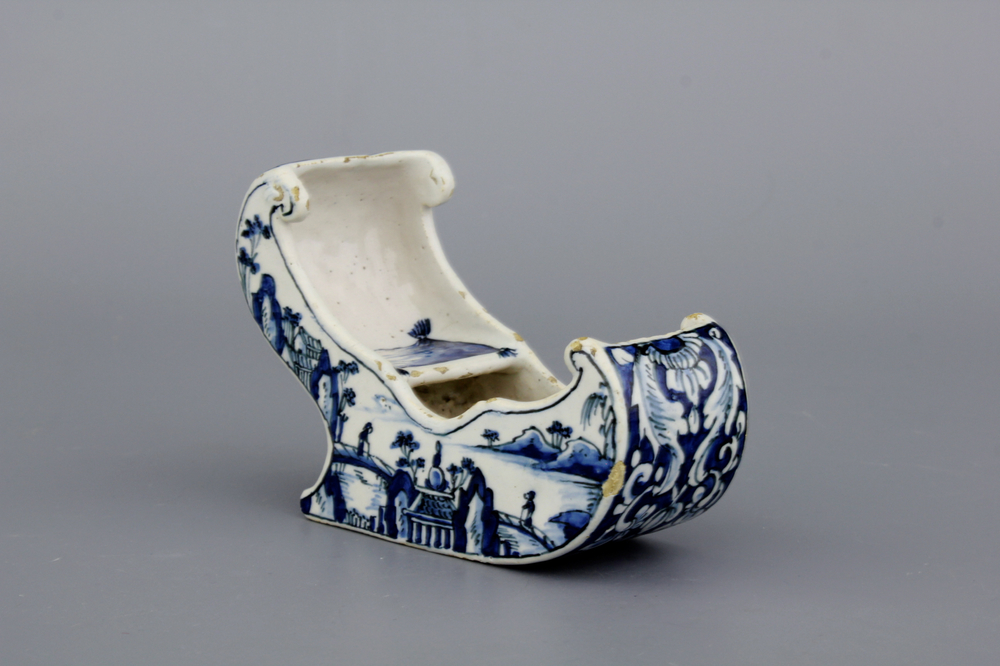 A rare Dutch Delft blue and white pipe holder, modelled as a sleigh, 18th C.