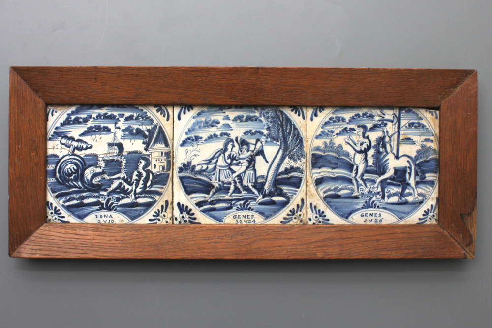 A framed set of 3 Dutch Delft blue and white biblical tiles, 18th C.