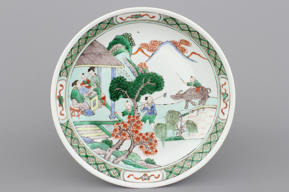 A fine famille verte plate with a village scene, 19th C.
