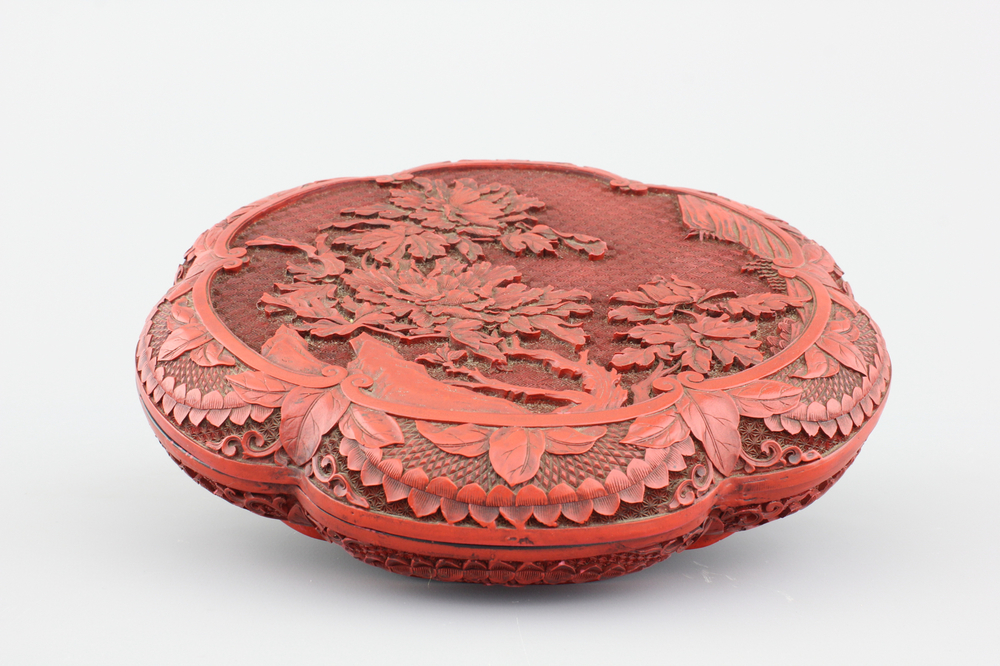 A Chinese carved cinnabar lacquer box and cover, 19th C.