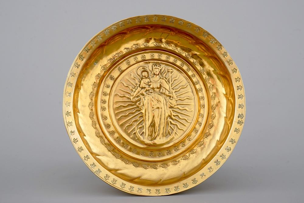 A good Nuremberg brass alms bowl showing Mary on the crescent moon, 16th C.