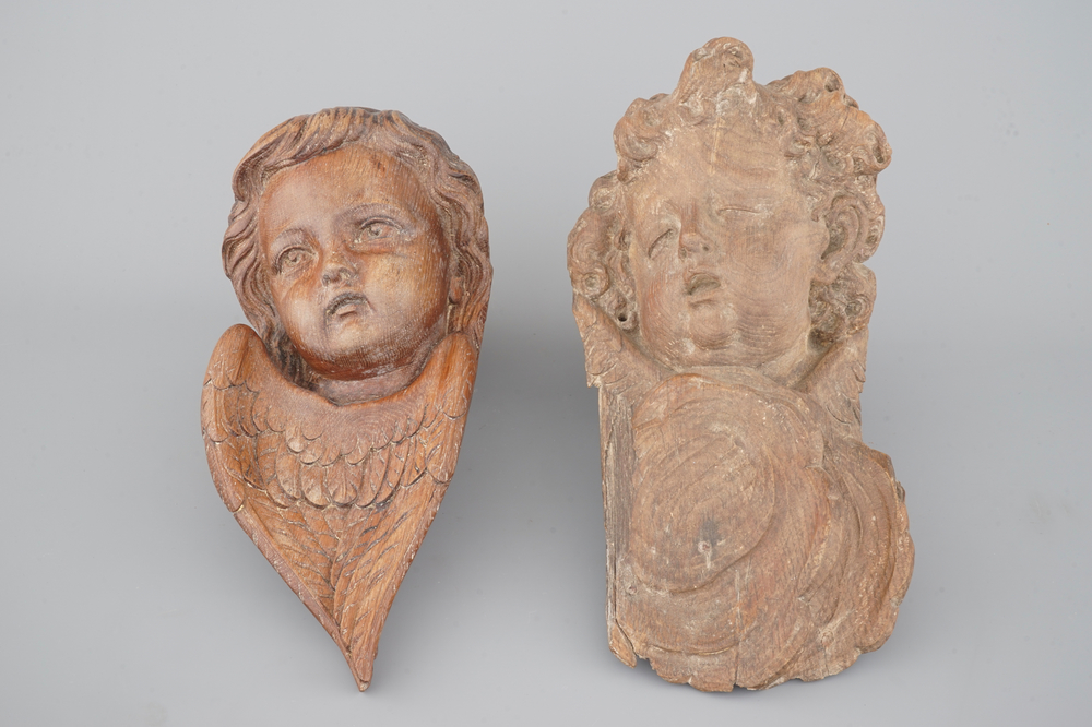 Two carved wood putto heads, 18th C.
