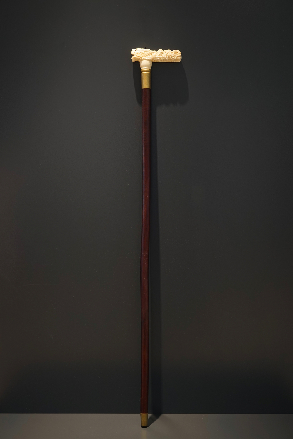 A Chinese carved ivory and wood walking stick or cane with a dragon's head, 19th C.