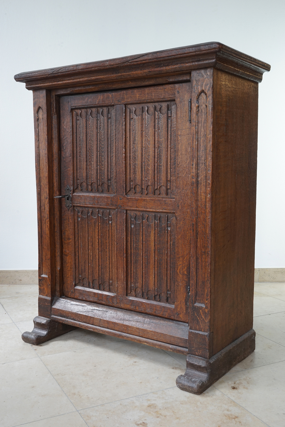 A gothic revival one door oak cabinet, 19th C.