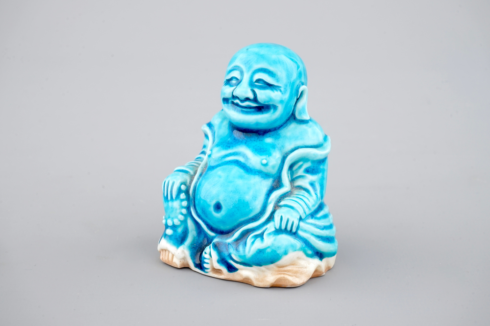 A Chinese porcelain turquoise figure of a seated Buddha, Kangxi